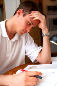Young student reading and taking notes